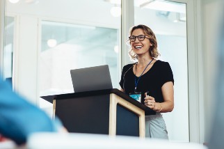 Safety professional woman leading a presentation at a podium
