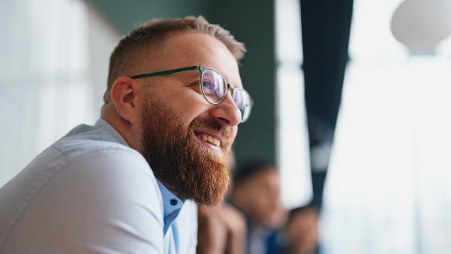 Closeup of a smiling safety professional man with a beard