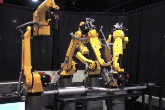 Closeup of robotic machinery assembling a exhaust pipe