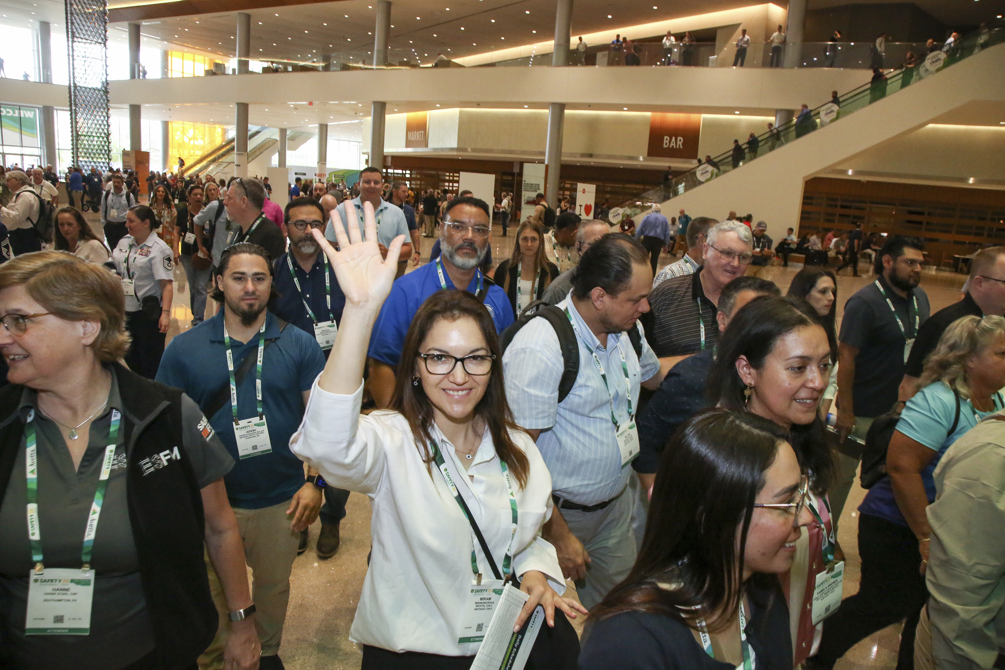 Woman waves in a crowd of people at ASSP
