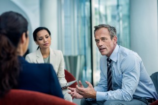 Safety professional man talking to two colleagues about their definition of risk