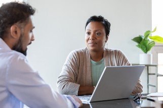 Safety professional speaking with worker in the office