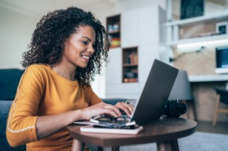 Young safety professional woman at home using her laptop to train workers remotely